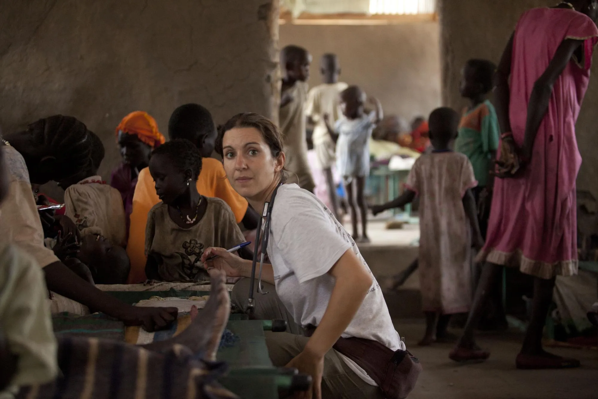 A clinician treating patients in a humanitarian crisis setting
